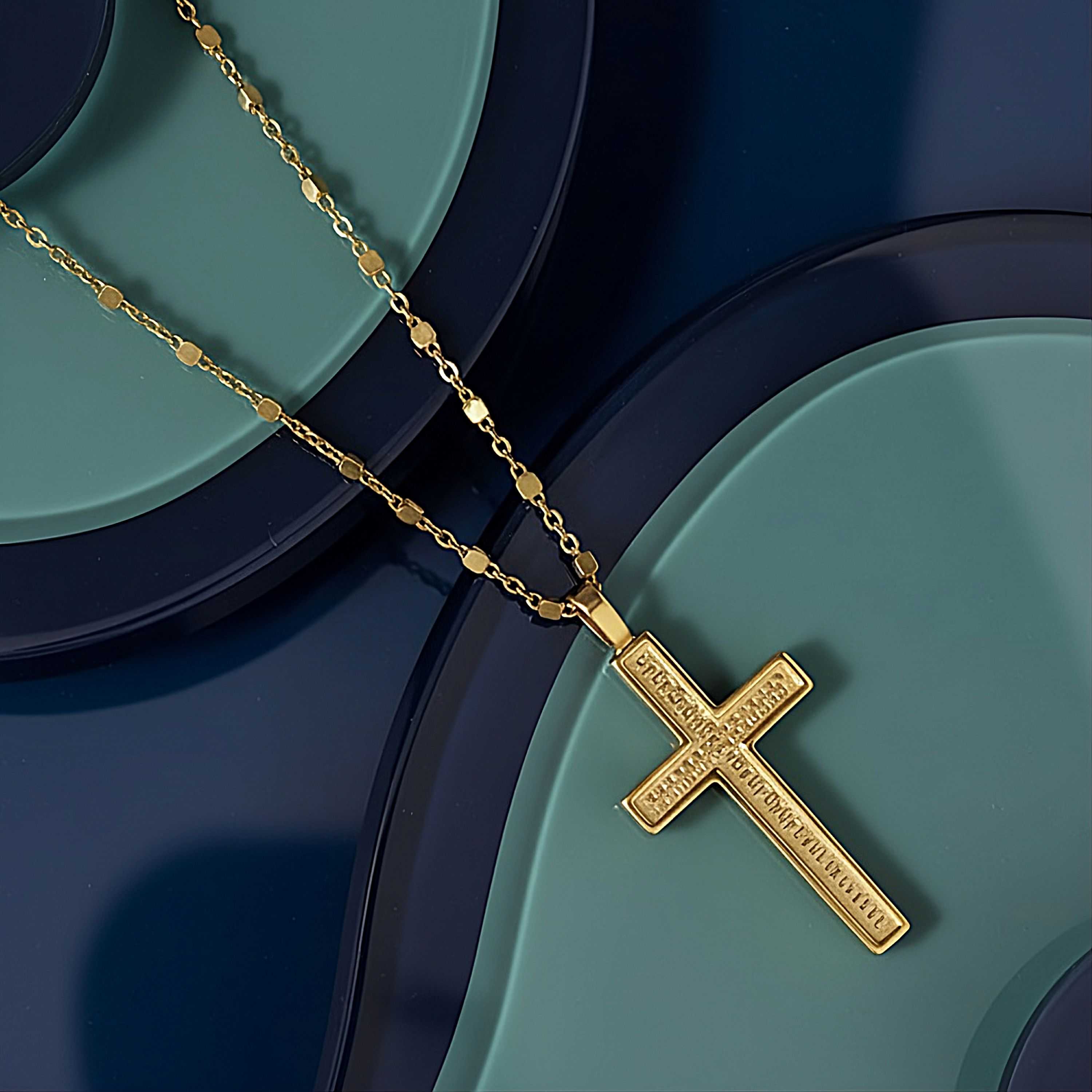 Luxury 18k gold cross necklace displayed on modern styling props, faith-based jewelry for Christian women by Rachel's Worth.