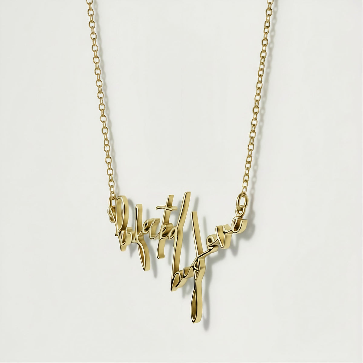 Close-up of the 2-inch Perfected by Love affirmation pendant highlighting its polished gold vermeil finish.