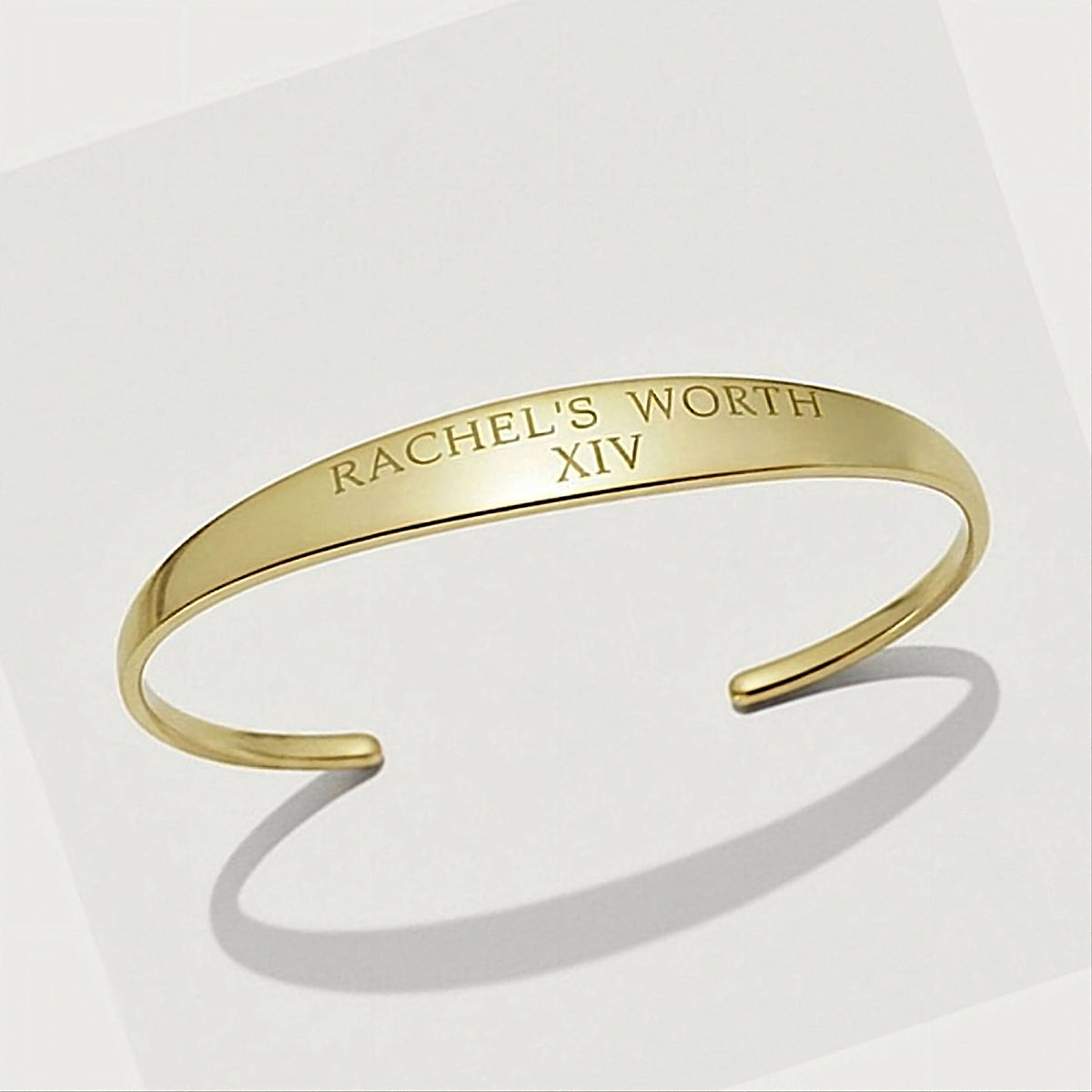 Front view of the XIV Solid 14K Gold Cuff Bracelet highlighting its substantial polished open-cuff silhouette.