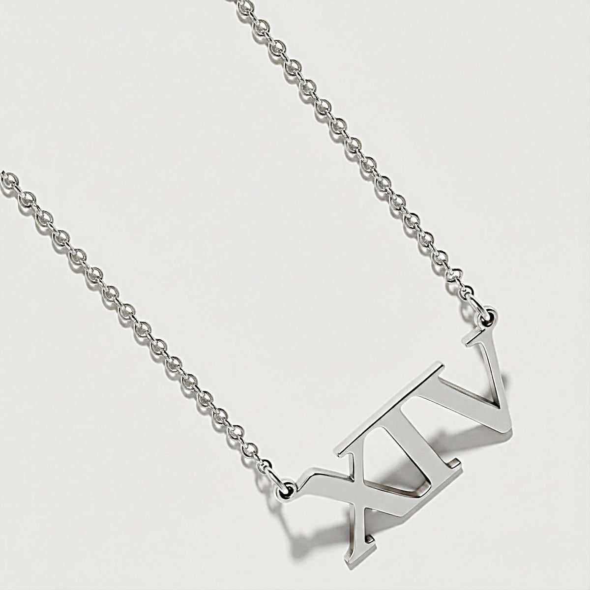 Close-up of the XIV pendant highlighting its polished .925 sterling silver finish.