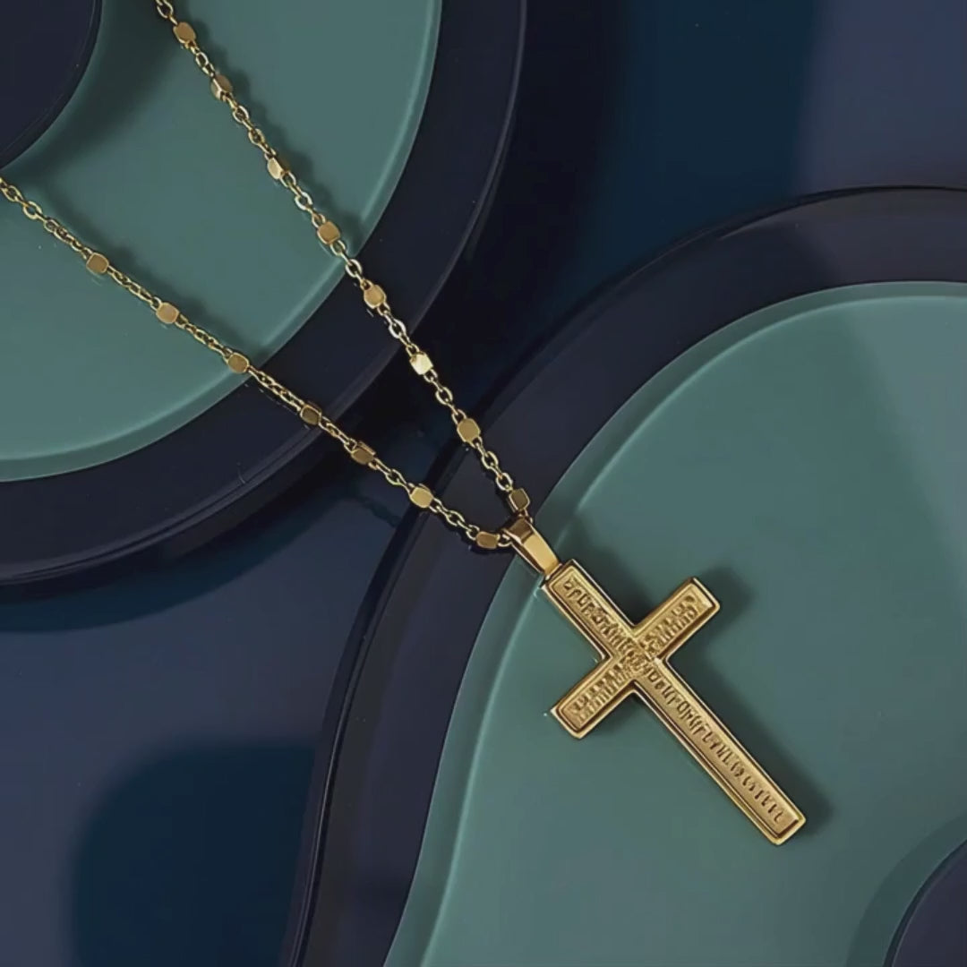 Rachel's Worth 18k Gold Cross Necklace on navy and blue abstract background