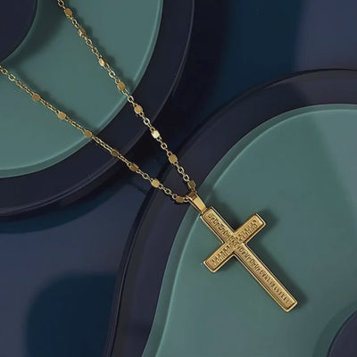 Rachel's Worth 18k Gold Cross Necklace on navy and blue abstract background