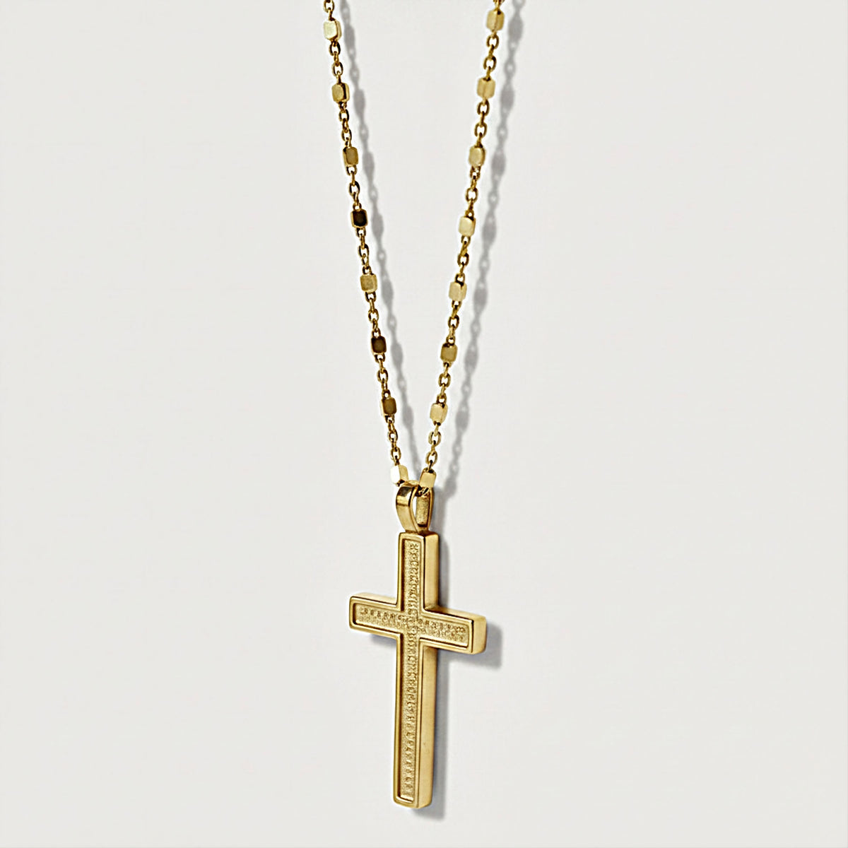 Close-up of the 18K Yellow Gold Vermeil Cross Pendant highlighting its refined minimalist design.