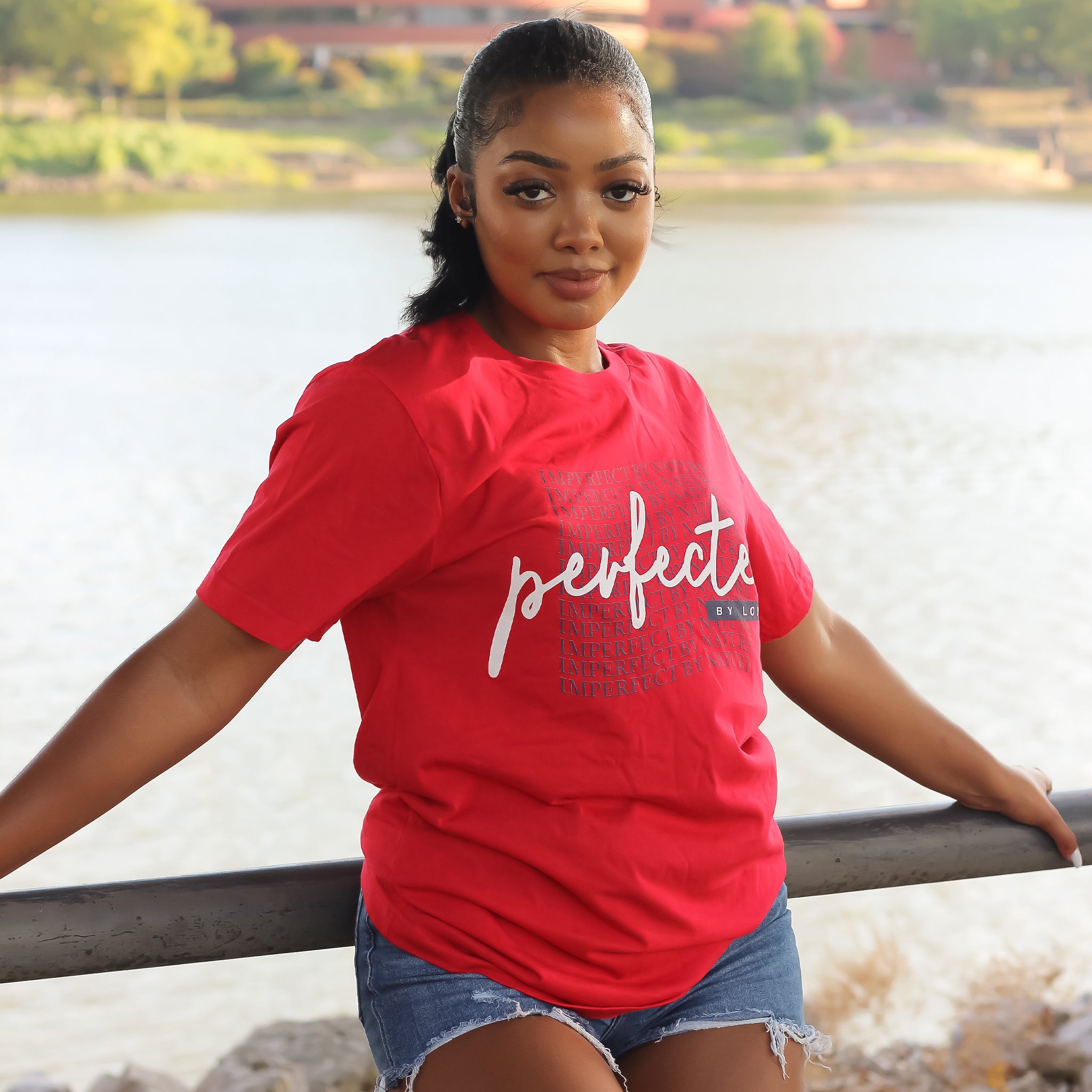 Woman wearing the Rachel's Worth Imperfect by Nature, Perfected by Love Wave Short Sleeve T-Shirt in a luxury editorial setting inspired by faith and everyday elegance.