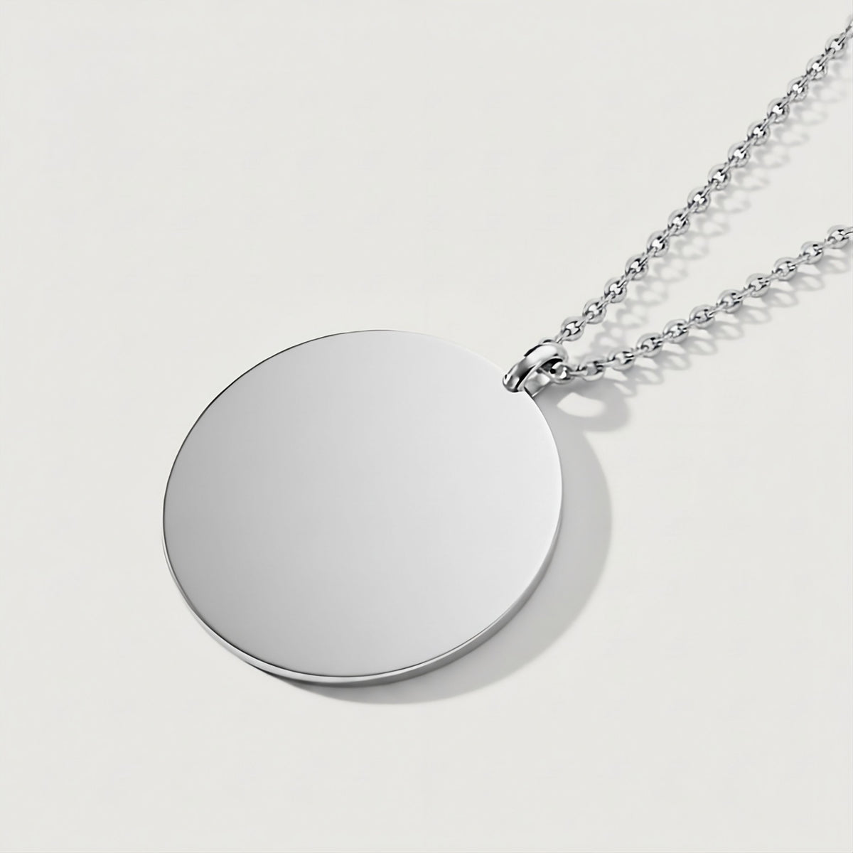 Back view of the Perfected by Love Sterling Silver Coin Pendant Necklace showing its polished construction.