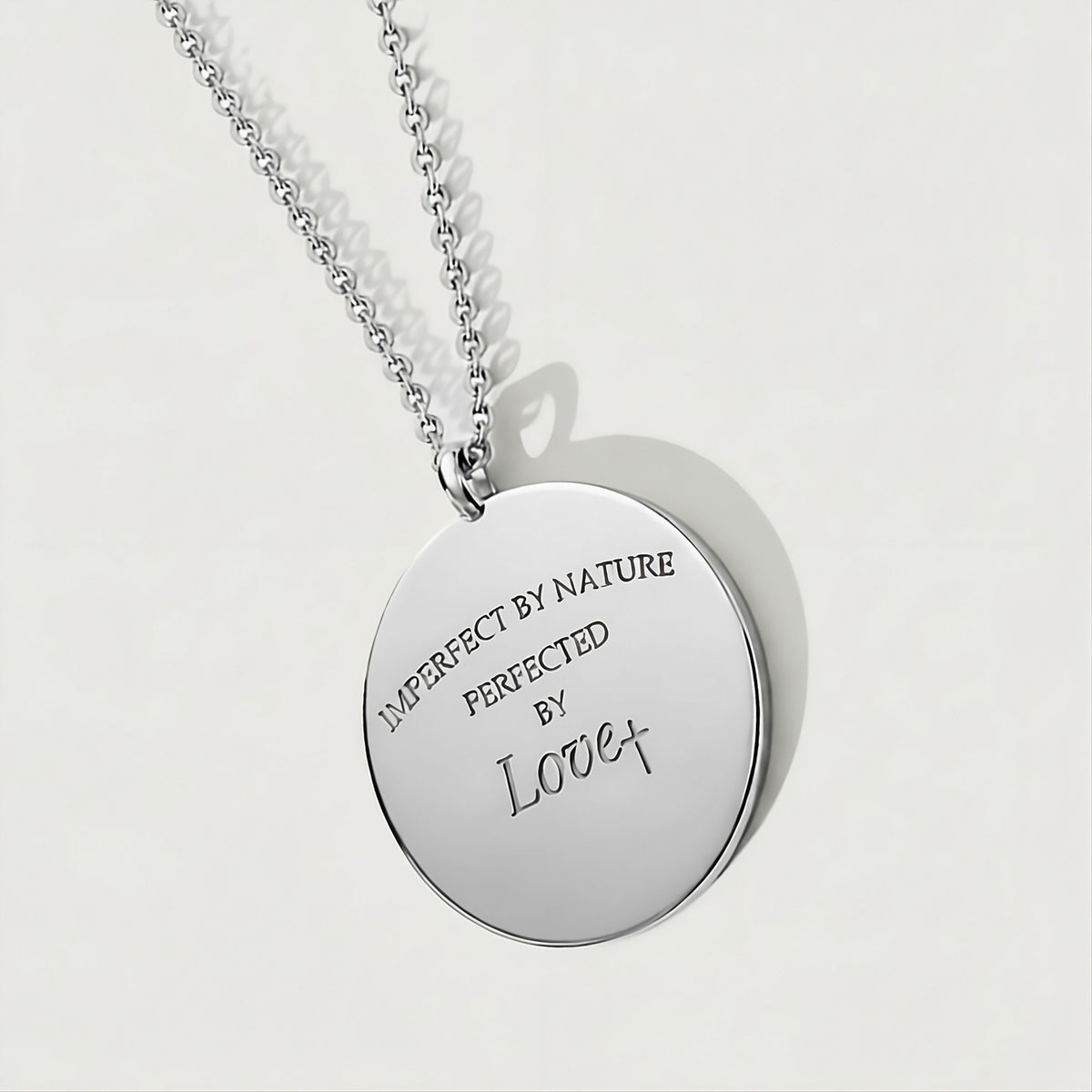 Front view of the Perfected by Love Sterling Silver Coin Pendant Necklace with a refined polished finish.