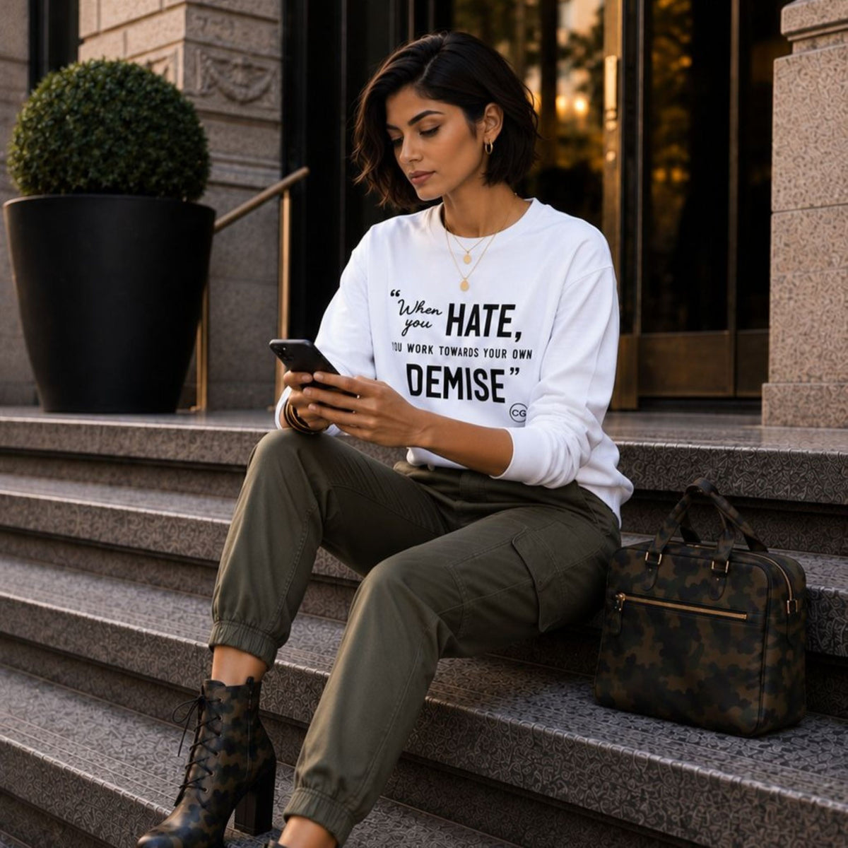 Woman wearing the Rachel's Worth Demise Long Sleeve Tee featuring the When You Hate, You Work Towards Your Own Demise message.