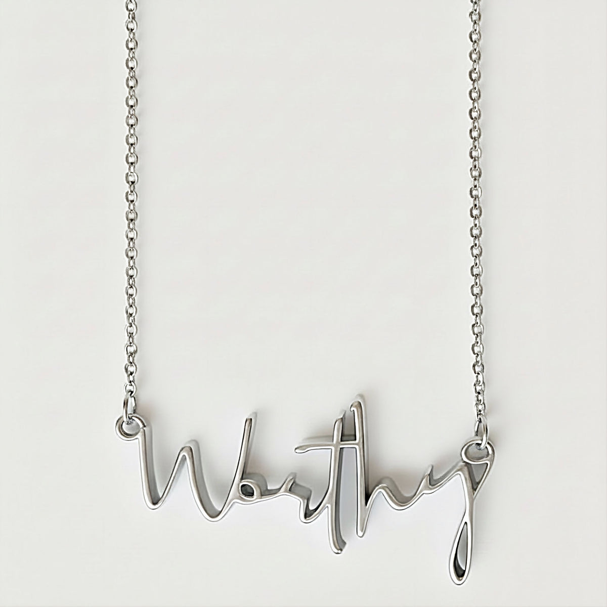 Front view of the Worthy Sterling Silver Affirmation Necklace featuring its refined elongated pendant.