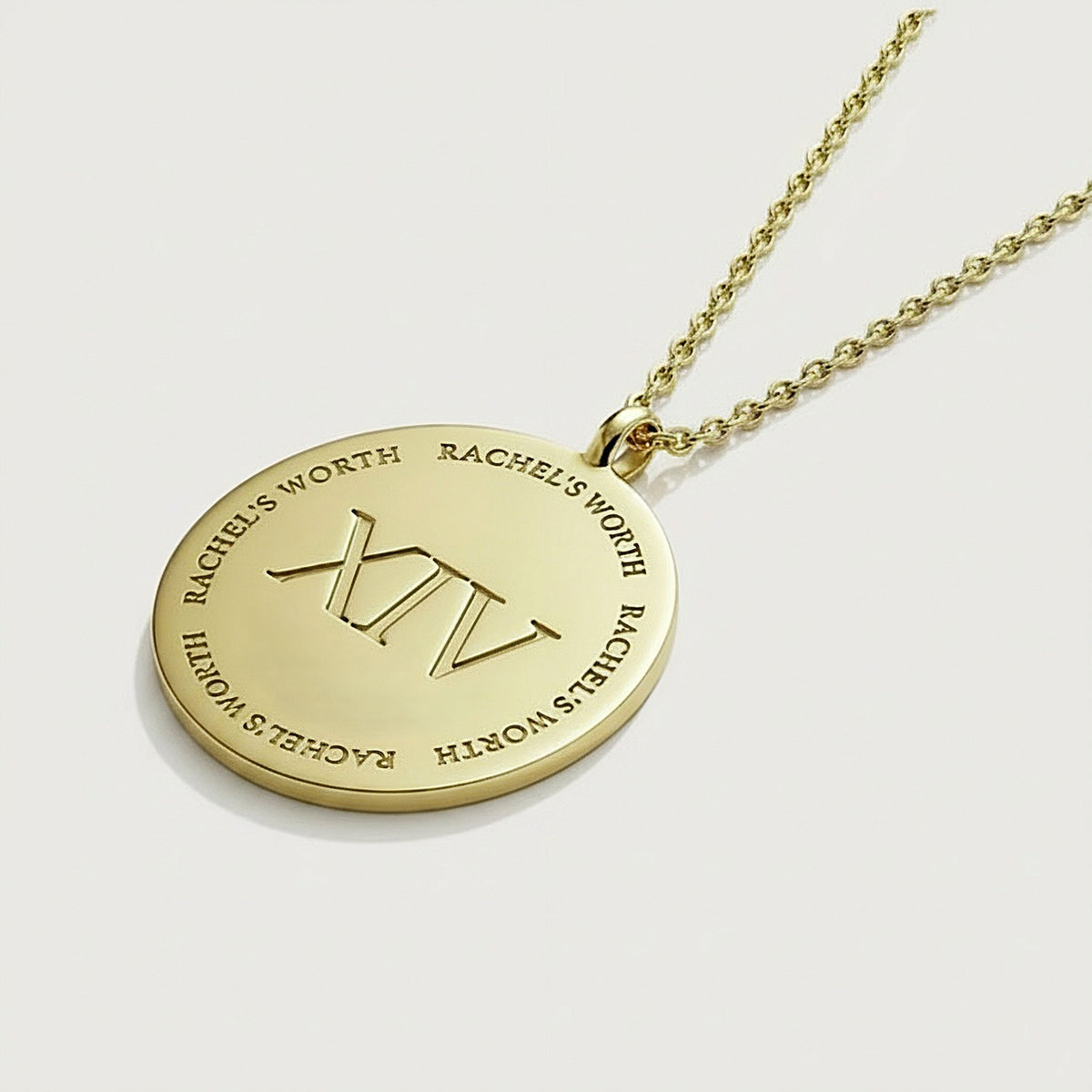 Detailed view of the XIV symbol on the Rachel's Worth Solid 14K Gold Coin Pendant Necklace.