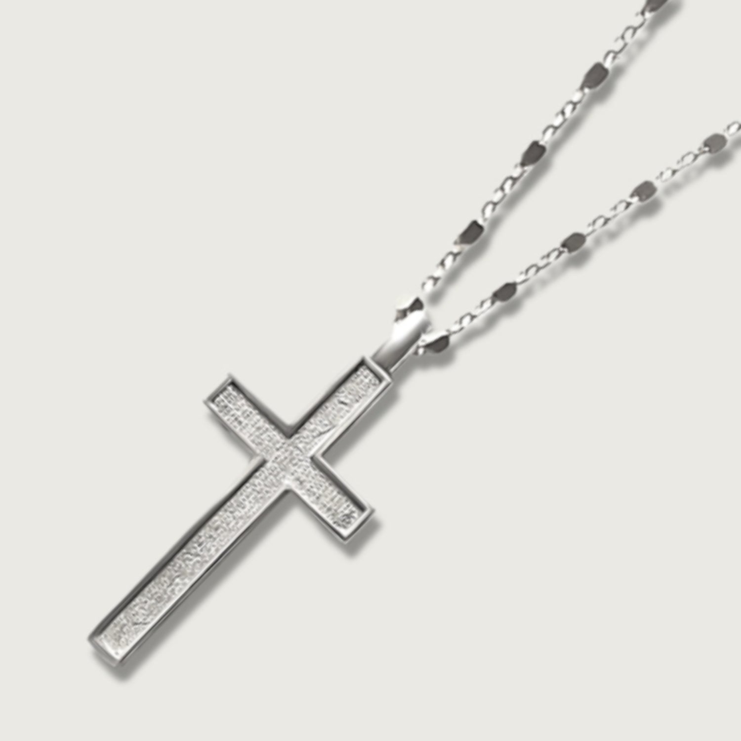 Close-up of sterling silver cross necklace pendant
