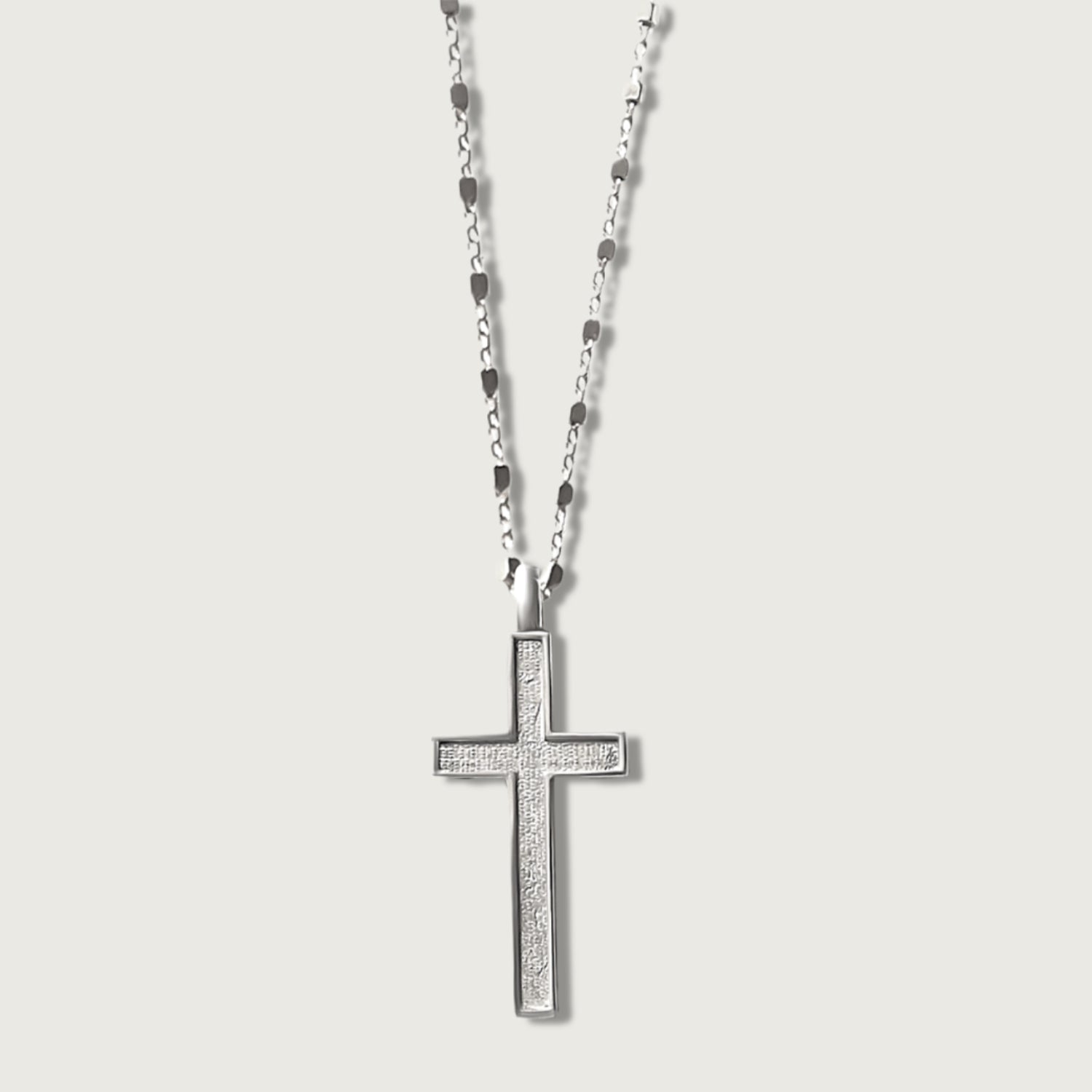 Rachel’s Worth® sterling silver cross necklace on gray background